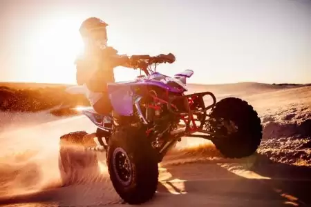 Sunset desert safari trip by quad bike